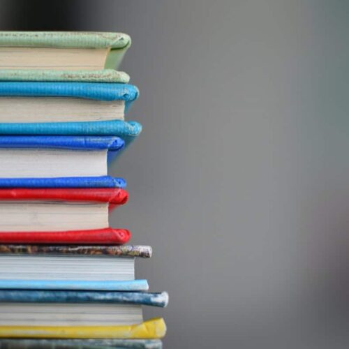 vertical stack of multicolored books